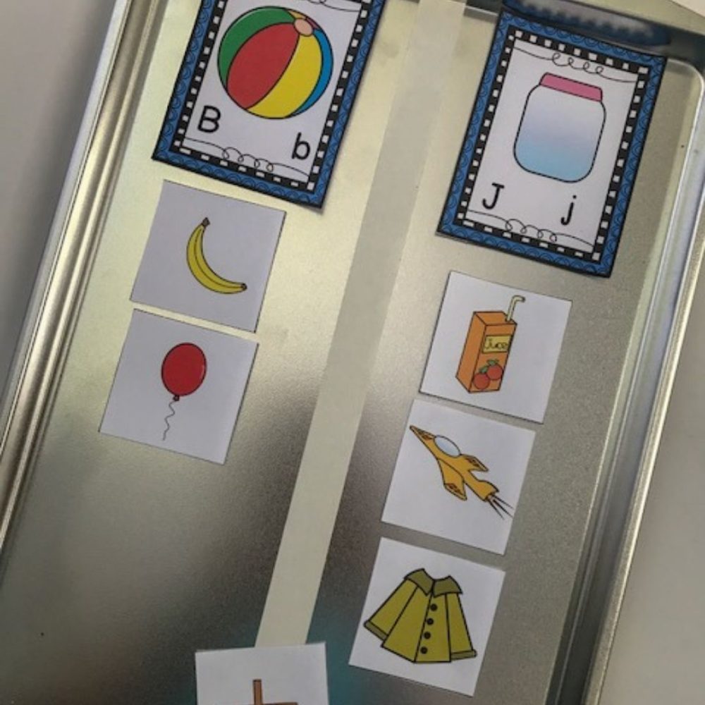 Cookie train with white line down the middle with a beginning consonant picture sort on it. On the left side is letter B with pictures of a bannana and balloon. The right side had letter J with pictures of a  juice box, jet, and jacket below.