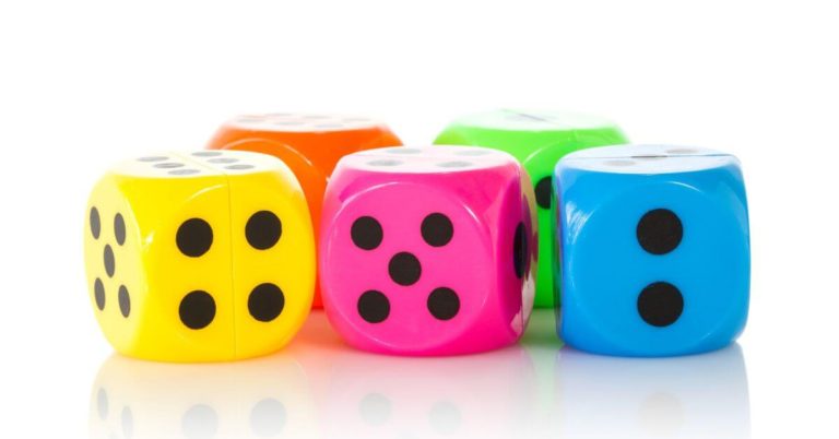 multi-colored dice. There is a yellow, pink, blue, orange, and green die.